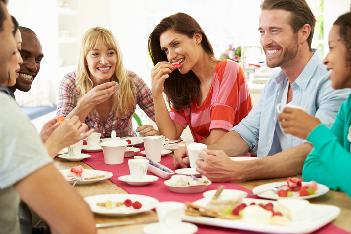 A group of friends eating dinner at home